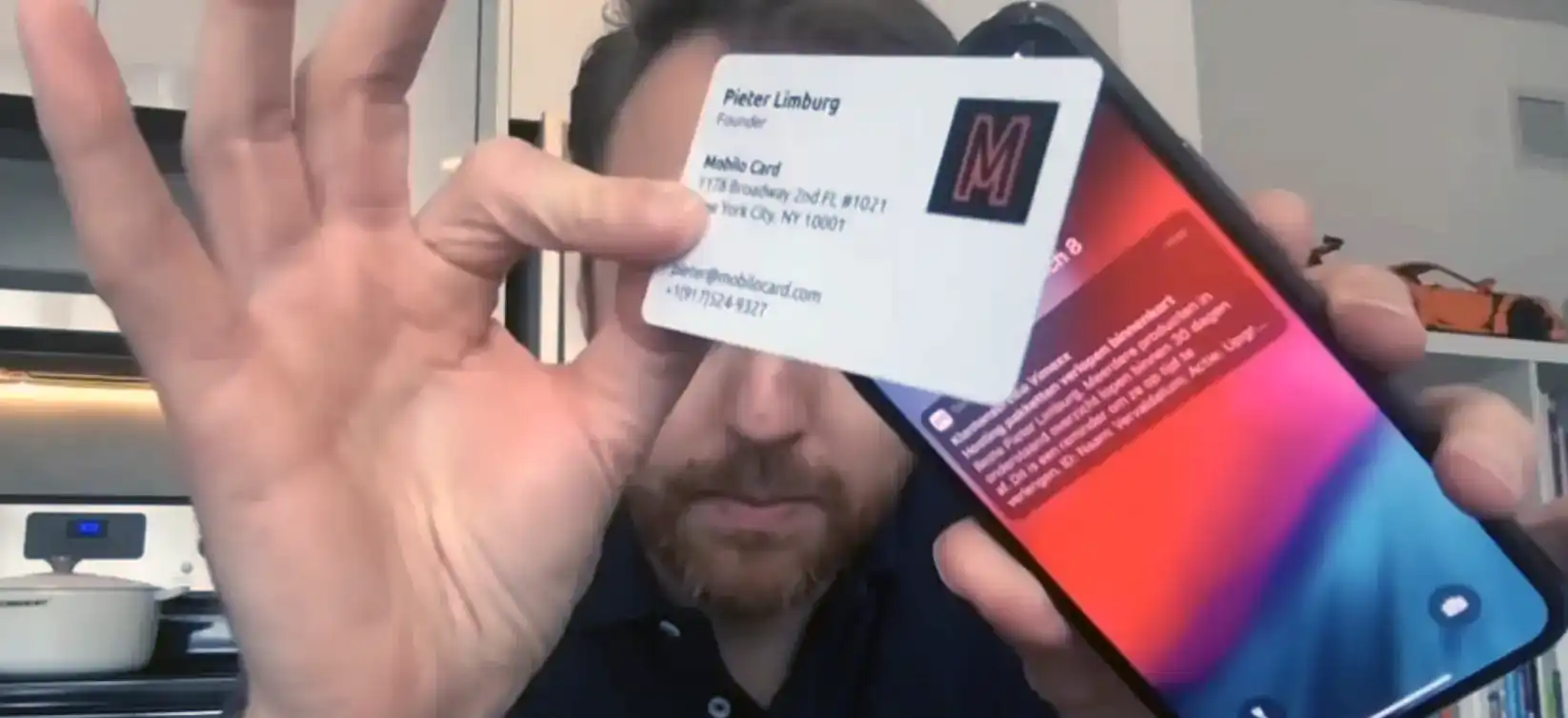 A person holidng Mobile physical business card